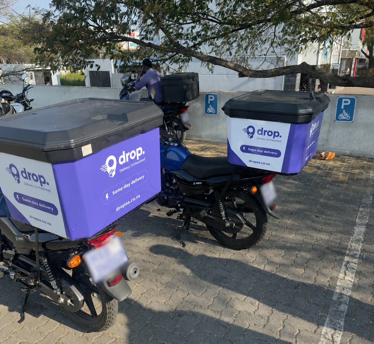 Drop-branded delivery motorcycles ready for same-day deliveries